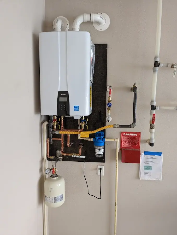 Professional plumber installing copper piping in a Sherborn home